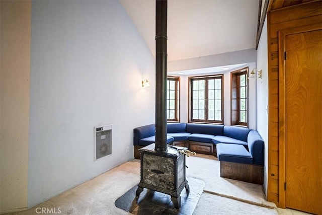 sitting room with high vaulted ceiling, carpet floors, and heating unit