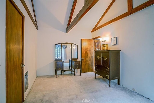 sitting room with beamed ceiling, carpet flooring, and high vaulted ceiling