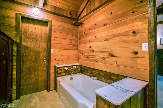 bathroom featuring wooden walls, a garden tub, and wood ceiling