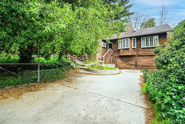 419 Lytle Ln, Lytle Creek, CA 92358 - view of front of property with stairs, a chimney, and concrete driveway