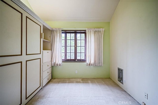 unfurnished bedroom with visible vents and light colored carpet