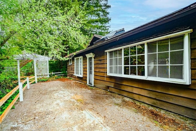 view of side of home featuring fence and a patio area
