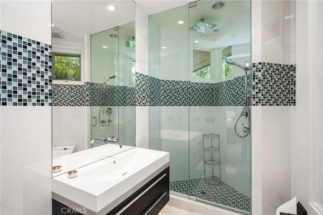 full bathroom with a shower stall and vanity