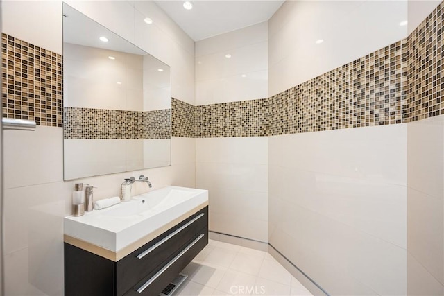 bathroom featuring tile walls, tile patterned flooring, and vanity