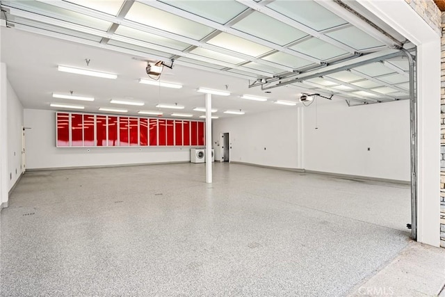 garage with baseboards and a garage door opener