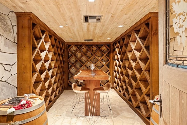 wine cellar featuring recessed lighting, stone flooring, visible vents, and wooden ceiling