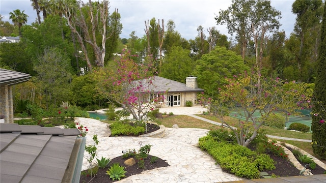 exterior space featuring a chimney and a patio area