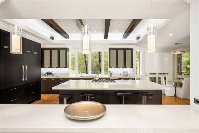 kitchen with plenty of natural light, beamed ceiling, and light countertops