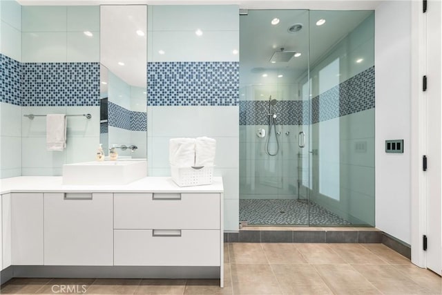 full bath featuring tile patterned floors, vanity, recessed lighting, and a shower stall