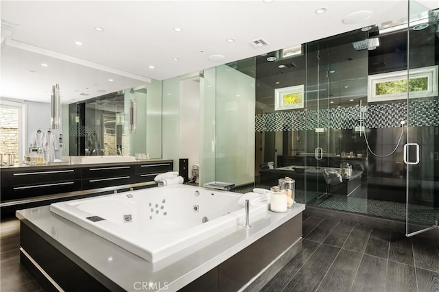 full bath featuring a stall shower, vanity, a whirlpool tub, visible vents, and recessed lighting