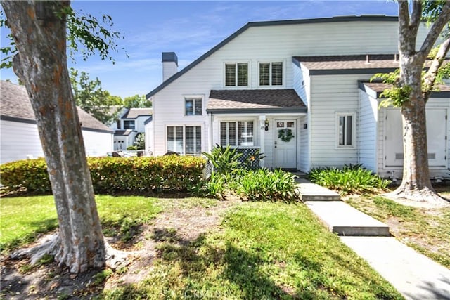 85 Briarglen, Irvine, CA 92614 - view of front facade featuring a chimney, a front lawn, and a shingled roof