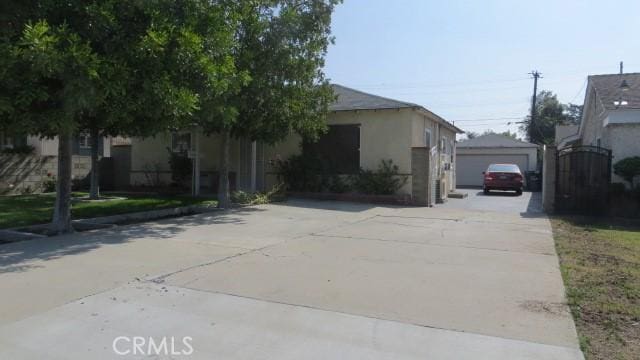 506 N Sunset Ave, Azusa, CA 91702 - view of property exterior featuring stucco siding and a detached garage