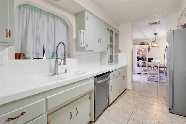 9415 Yucca St, Apple Valley, CA 92308 - kitchen with a sink, light tile patterned flooring, stainless steel appliances, light countertops, and visible vents