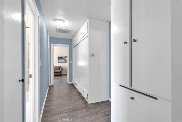 9415 Yucca St, Apple Valley, CA 92308 - hallway featuring baseboards, wood finished floors, visible vents, and a textured ceiling