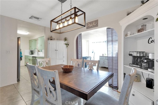 9415 Yucca St, Apple Valley, CA 92308 - dining area featuring arched walkways, visible vents, and light tile patterned floors