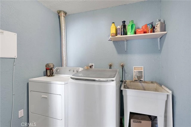 9415 Yucca St, Apple Valley, CA 92308 - laundry room with a textured ceiling, washer and dryer, a sink, and laundry area