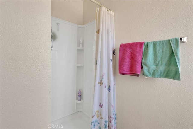 9415 Yucca St, Apple Valley, CA 92308 - full bathroom featuring a textured wall and a shower with shower curtain