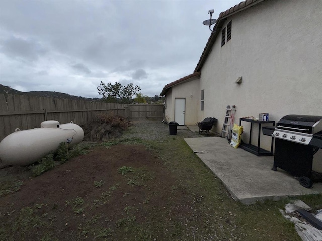 view of yard with a fenced backyard and a patio
