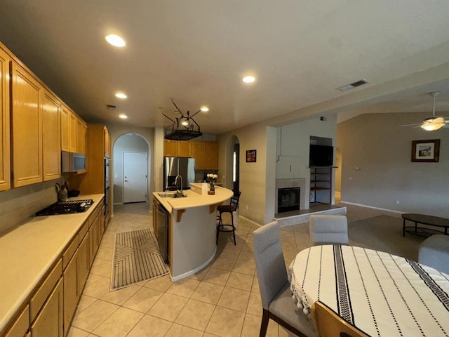 kitchen featuring recessed lighting, light countertops, visible vents, arched walkways, and black appliances