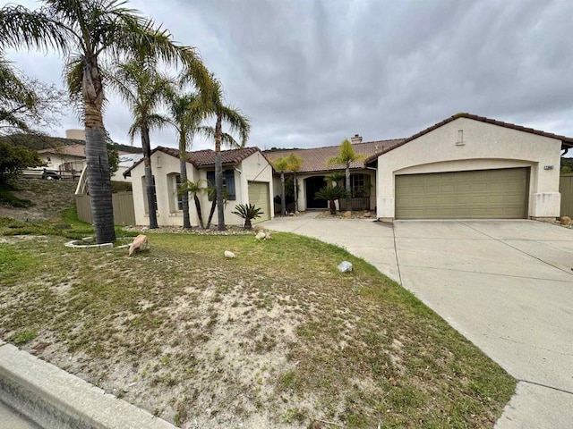 view of front of home featuring an attached garage, stucco siding, and driveway