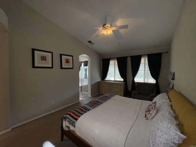 bedroom with lofted ceiling, visible vents, arched walkways, carpet floors, and baseboards