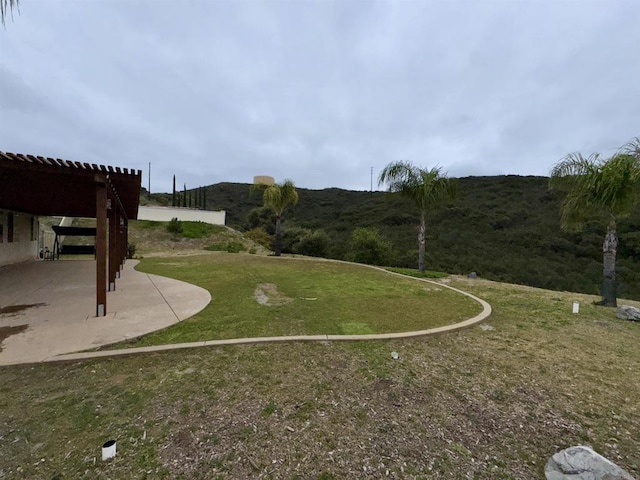 view of property's community with a lawn and a patio area