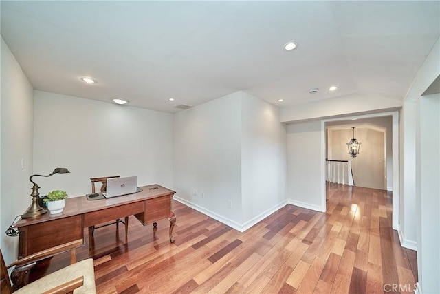 office space with recessed lighting, baseboards, an inviting chandelier, and light wood-type flooring