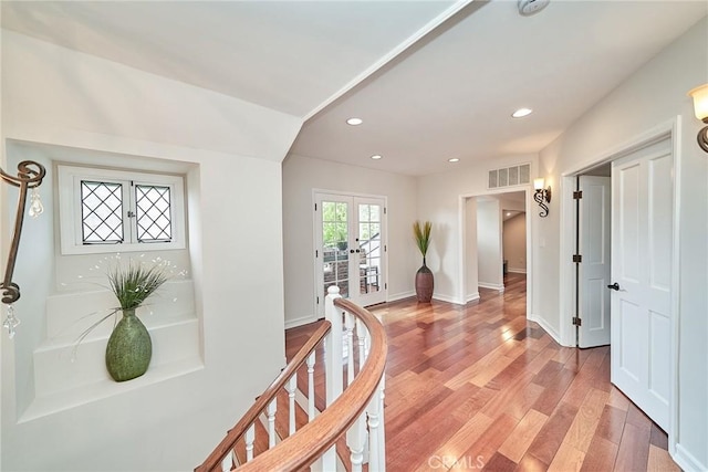 entryway featuring visible vents, light wood-style floors, baseboards, recessed lighting, and french doors