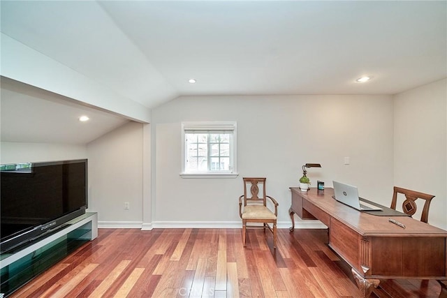 home office featuring recessed lighting, baseboards, vaulted ceiling, and hardwood / wood-style flooring