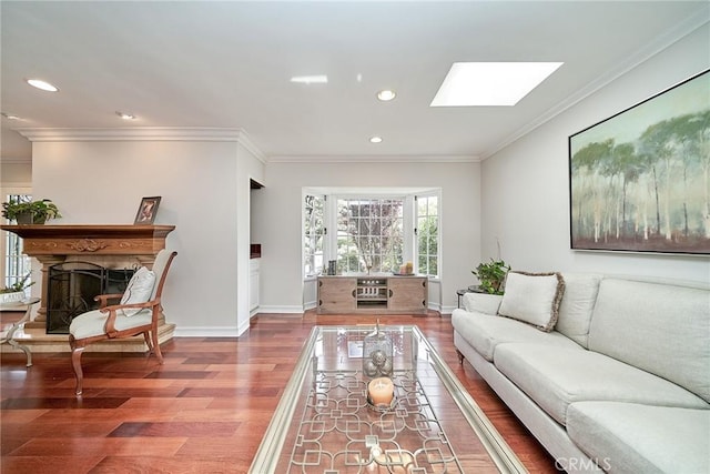 living room with crown molding, recessed lighting, a skylight, and wood finished floors