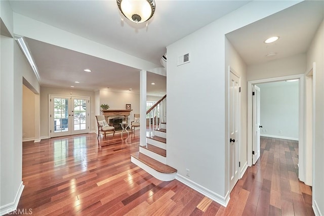 hall featuring french doors, visible vents, stairway, wood-type flooring, and recessed lighting