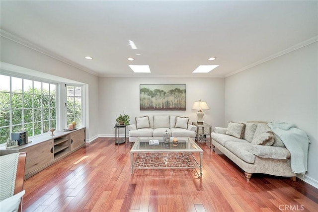 living area with crown molding, recessed lighting, a skylight, and light wood-style floors