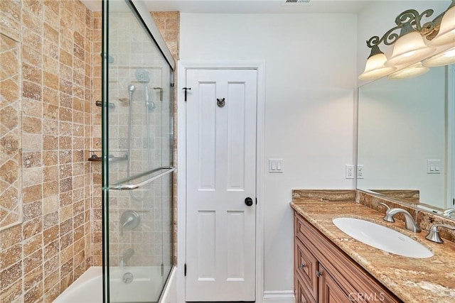 full bathroom featuring enclosed tub / shower combo, visible vents, and vanity