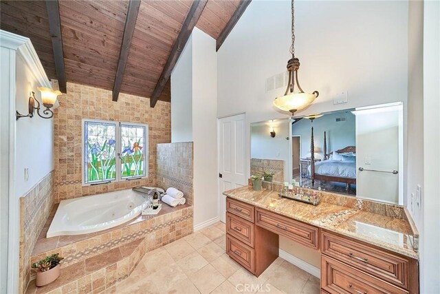 bathroom with a jetted tub, wooden ceiling, ensuite bathroom, beamed ceiling, and visible vents