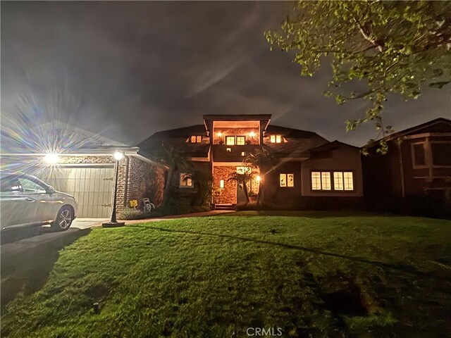 view of front of property featuring a yard and aphalt driveway