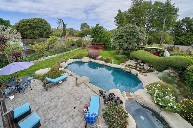 pool with a patio and fence