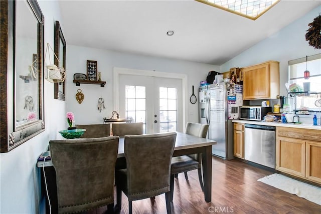kitchen featuring french doors, dark wood-style floors, lofted ceiling, pendant lighting, and appliances with stainless steel finishes