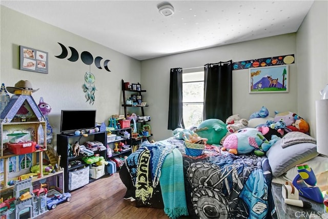 bedroom with wood finished floors
