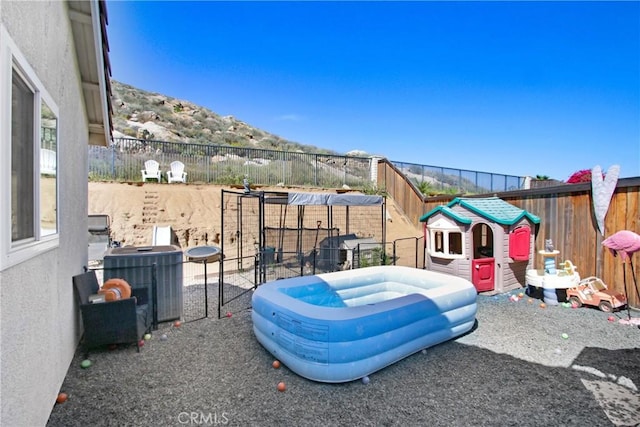 view of patio / terrace featuring fence and cooling unit