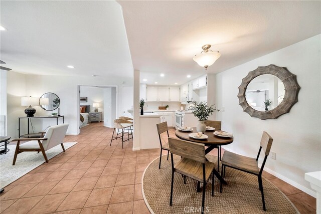 dining space featuring recessed lighting and light tile patterned floors