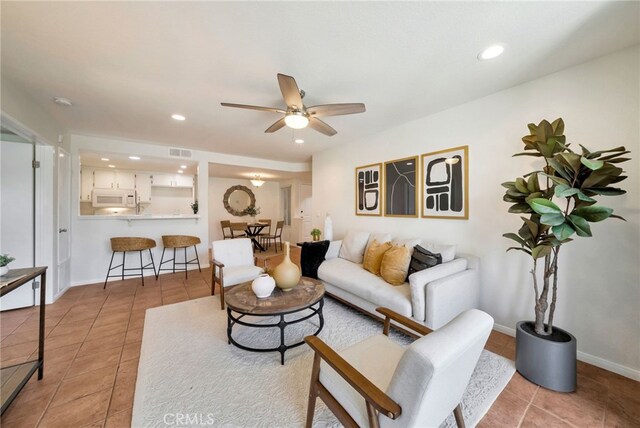 living area with recessed lighting, visible vents, ceiling fan, and light tile patterned floors