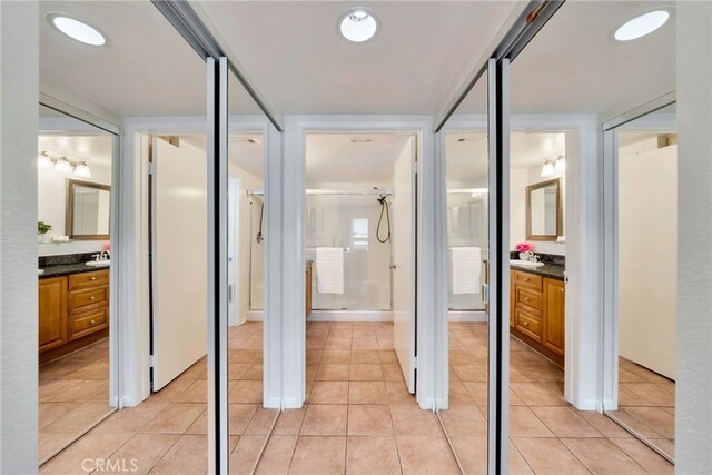 full bath featuring vanity, a shower stall, and tile patterned flooring