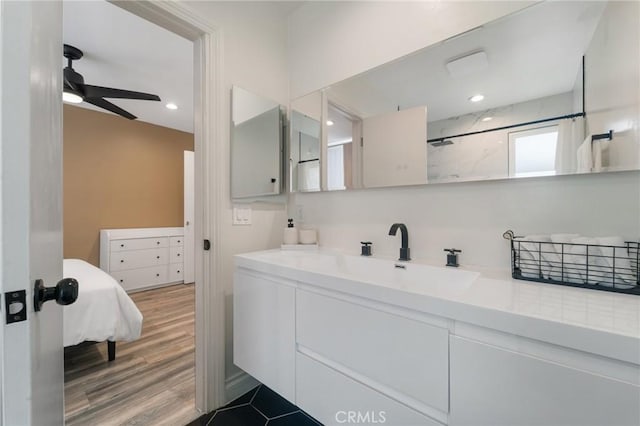 bathroom featuring recessed lighting, wood finished floors, vanity, a shower, and ceiling fan