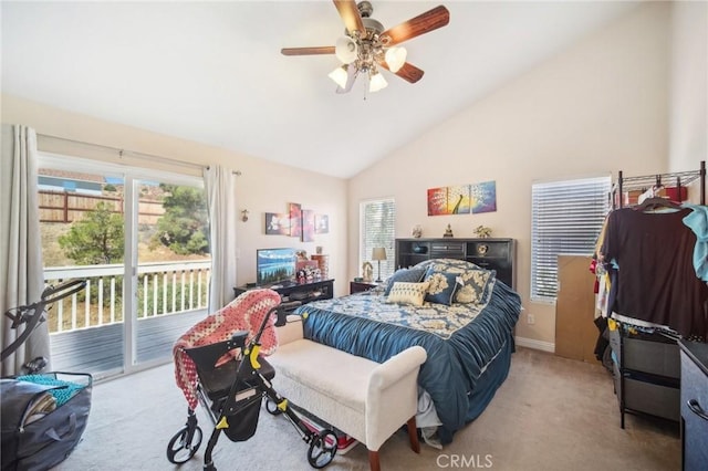 carpeted bedroom featuring ceiling fan, access to exterior, high vaulted ceiling, and multiple windows