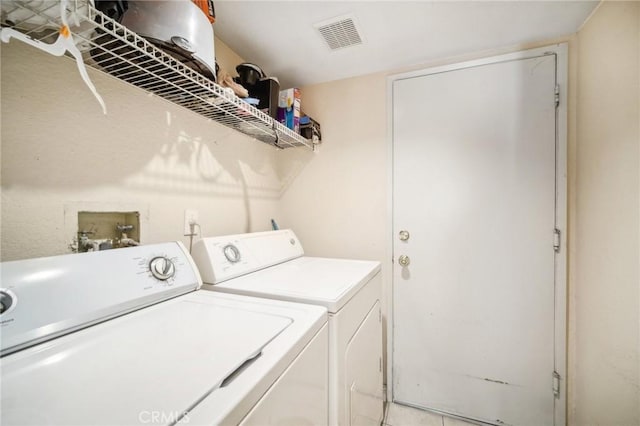 laundry room with visible vents, separate washer and dryer, and laundry area