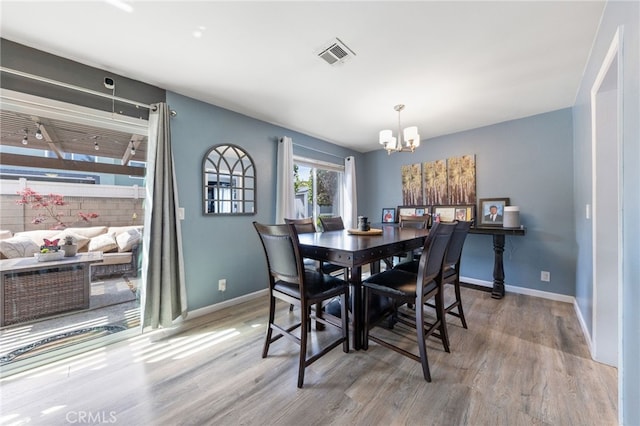 2102 Tern Bay Ln, Lakewood, CA 90712 - dining room with a chandelier, wood finished floors, and baseboards