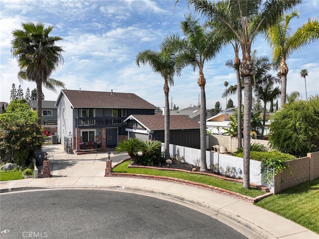 2102 Tern Bay Ln, Lakewood, CA 90712 - view of front facade with fence, a balcony, and roof with shingles