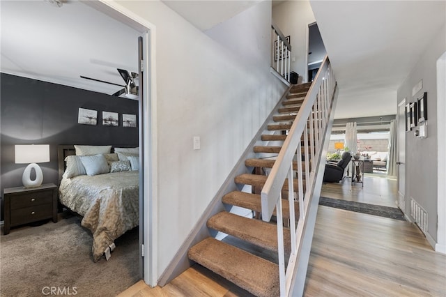 2102 Tern Bay Ln, Lakewood, CA 90712 - staircase featuring a ceiling fan and wood finished floors