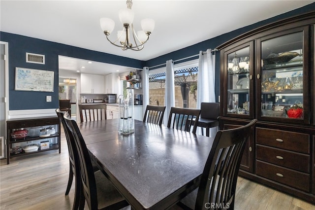 2102 Tern Bay Ln, Lakewood, CA 90712 - dining area featuring a chandelier and light wood finished floors