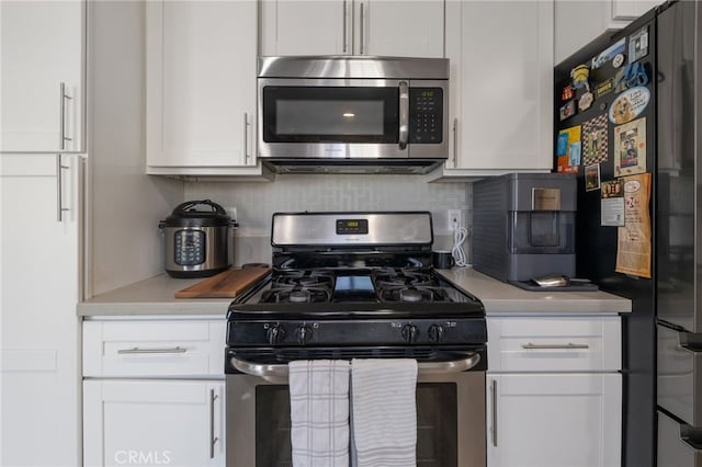 2102 Tern Bay Ln, Lakewood, CA 90712 - kitchen with stainless steel appliances, light countertops, white cabinetry, and decorative backsplash
